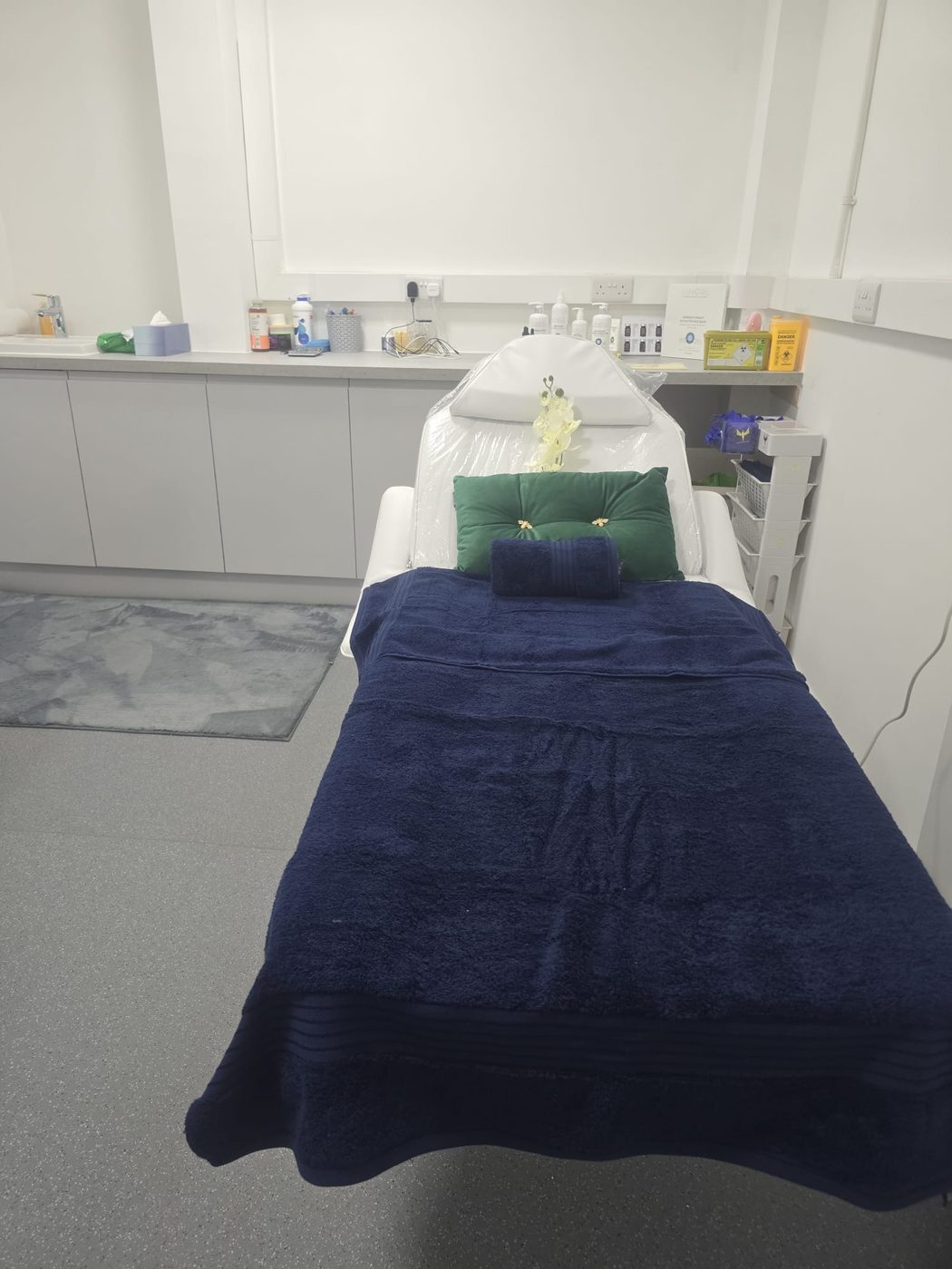 A treatment bed prepared with fresh towels ahead of an appointment